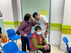 私董善愛主席黃君俠於社區探訪期間，俯身與長者細心交流，了解她們的需要與近況